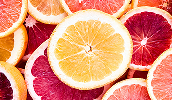 Assorted grapefruit slices in shades of yellow, pink, and red.